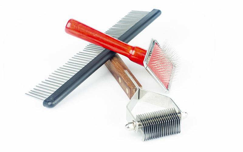Dog grooming tools to include brush, rake and comb